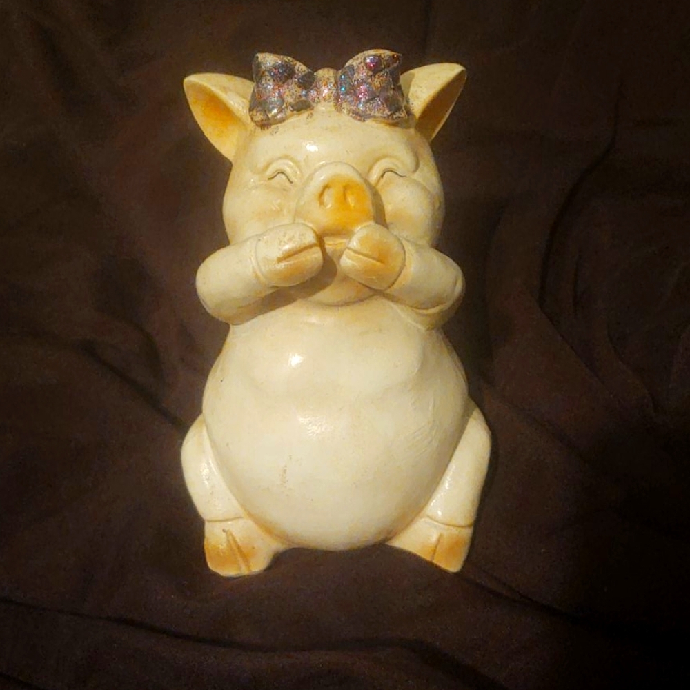 Laughing pig figurine